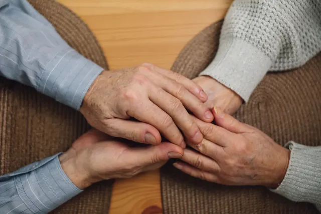 Two pairs of hands held together